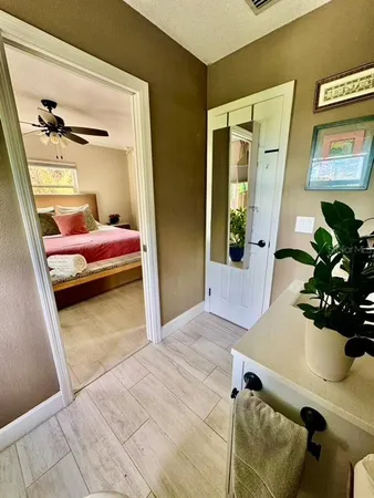 a bathroom with a granite countertop bathtub sink vanity mirror and toilet
