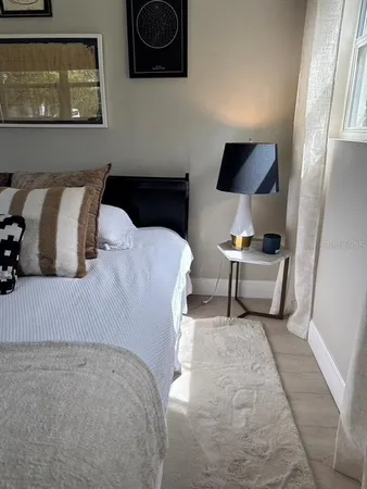 a view of patio with table and chairs under an umbrella with wooden floor