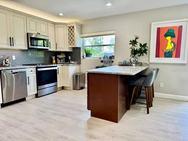 a living room with furniture a table and a large window