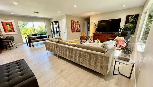 a view of a dining room with furniture window and wooden floor