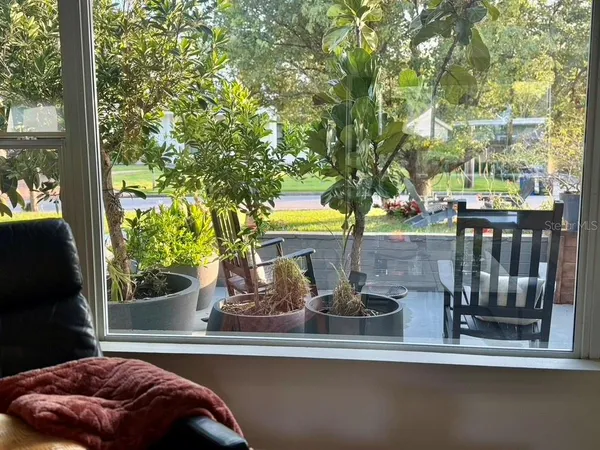 a living room with furniture and a flat screen tv with a large window