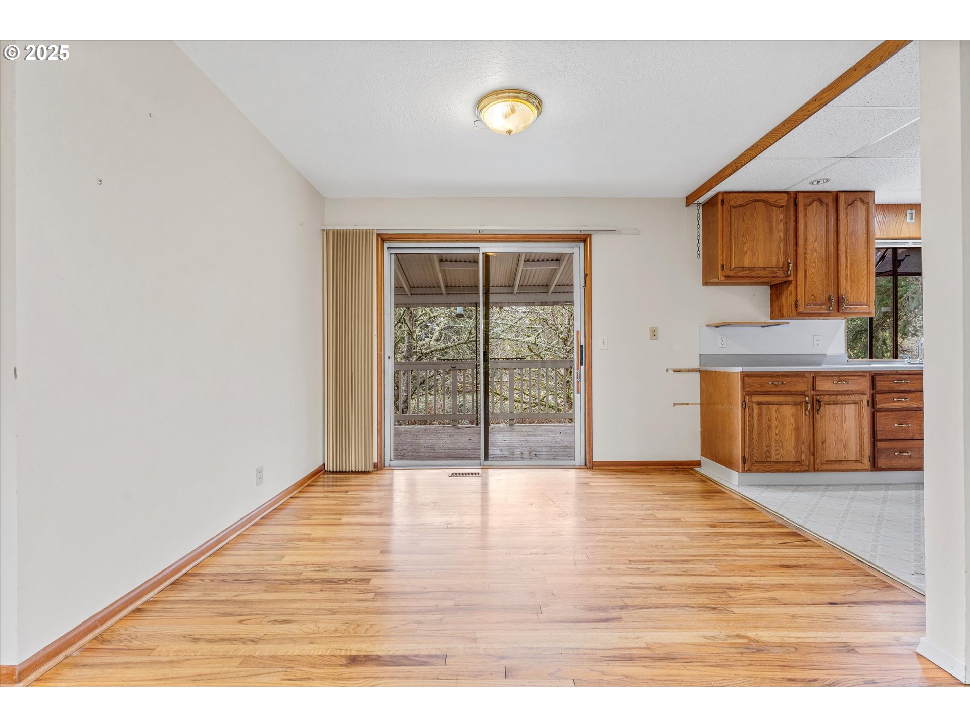 15051 Southeast Bluff Road Sandy, OR 97055 - Photo 11 of 41 a view of an empty room with window and wooden floor