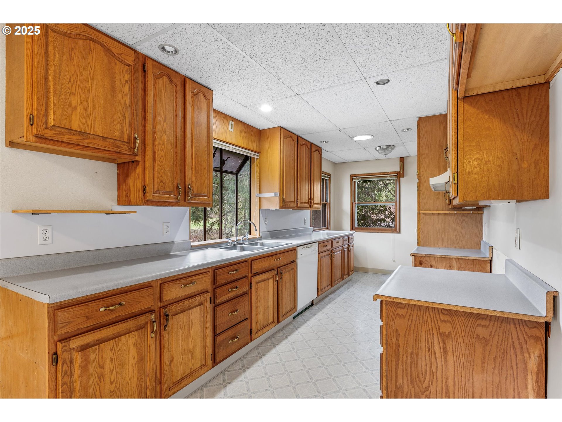 15051 Southeast Bluff Road Sandy, OR 97055 - Photo 13 of 41 a kitchen with stainless steel appliances granite countertop a sink dishwasher stove and refrigerator with wooden cabinets