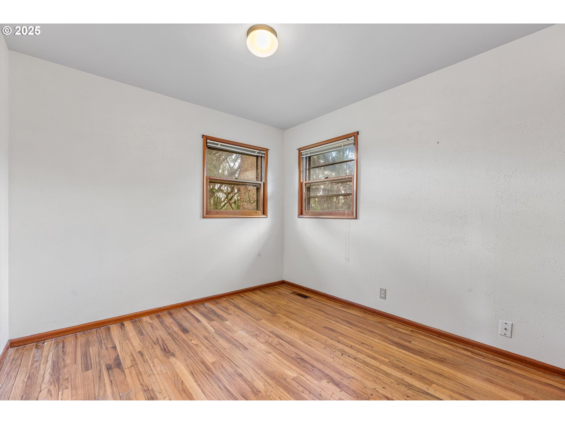 15051 Southeast Bluff Road Sandy, OR 97055 - Photo 19 of 41 an empty room with wooden floor and window