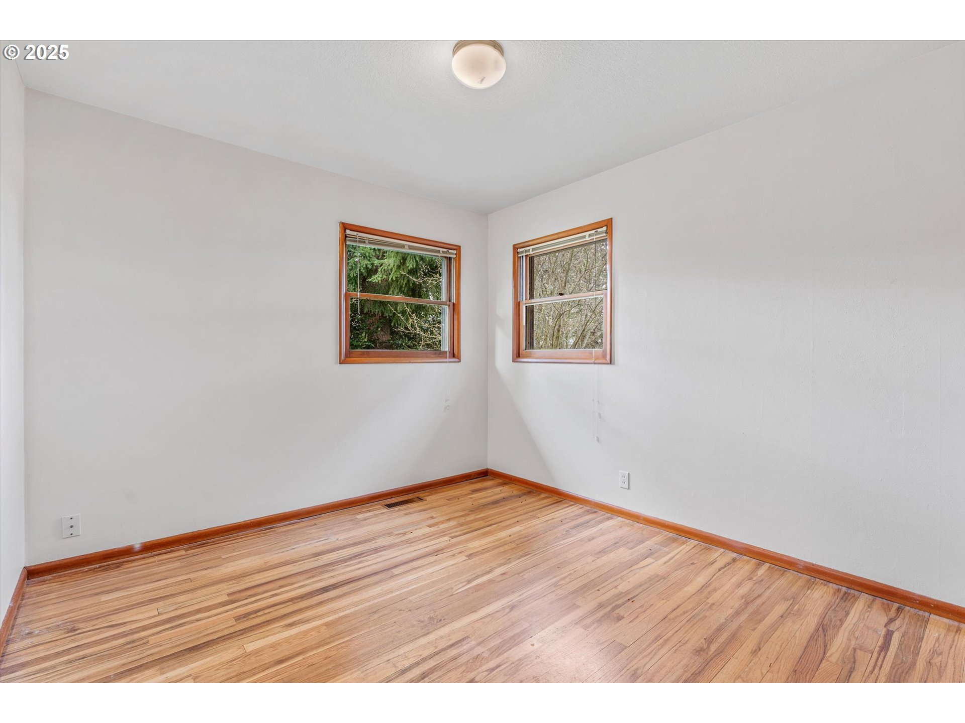 15051 Southeast Bluff Road Sandy, OR 97055 - Photo 20 of 41 a view of an empty room with wooden floor and a window