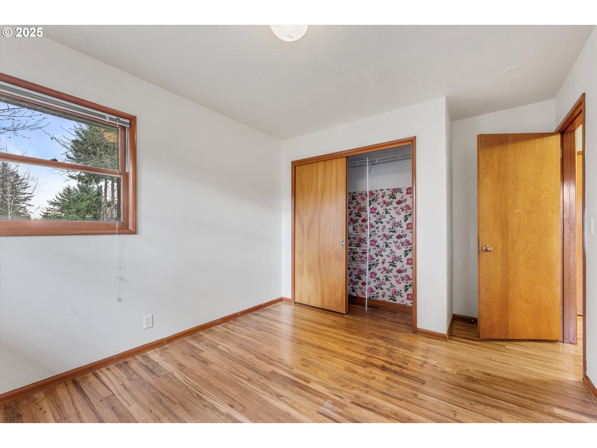 15051 Southeast Bluff Road Sandy, OR 97055 - Photo 21 of 41 a view of an empty room with wooden floor and a window