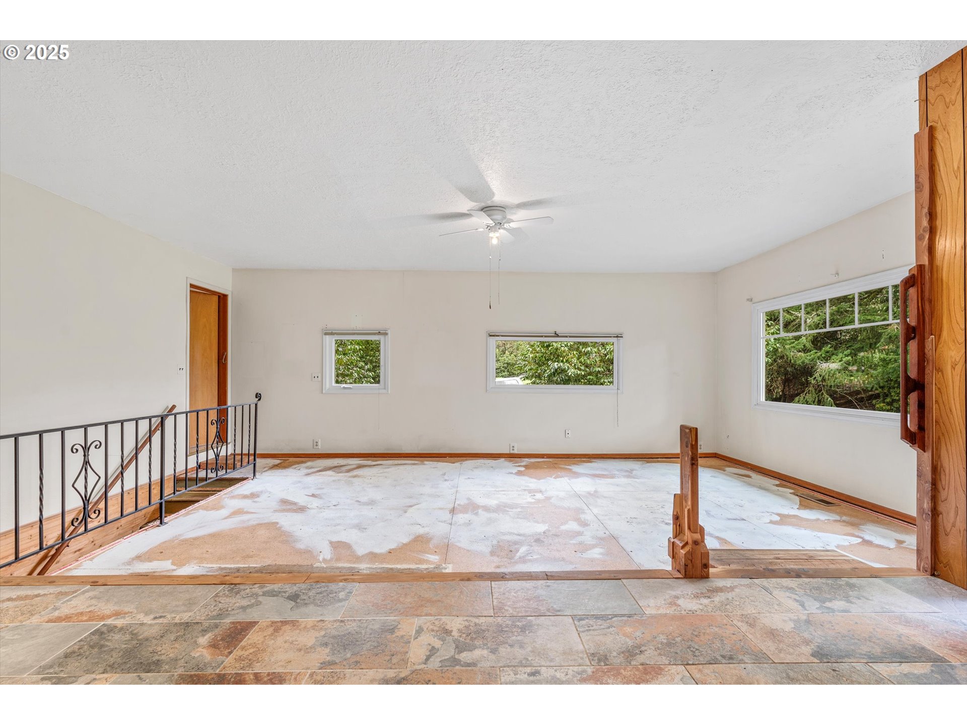 15051 Southeast Bluff Road Sandy, OR 97055 - Photo 10 of 41 a view of a livingroom with wooden floor and a ceiling fan