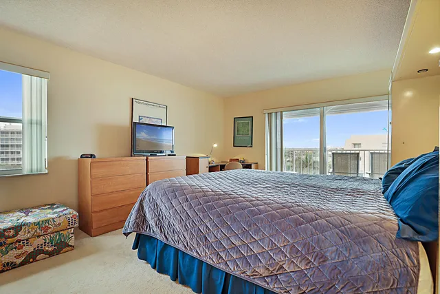 a bedroom with a bed a window and dresser