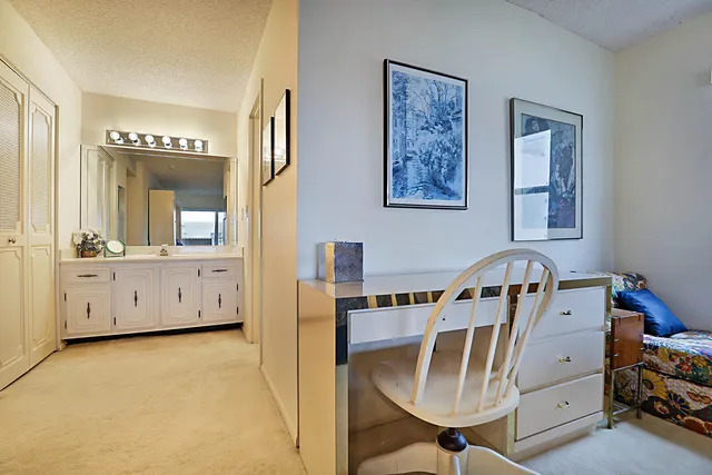 a view of a bedroom with bed and window