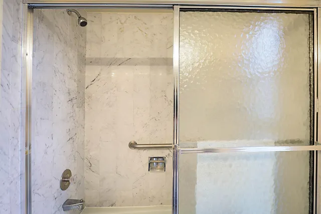 a bathroom with a glass shower door