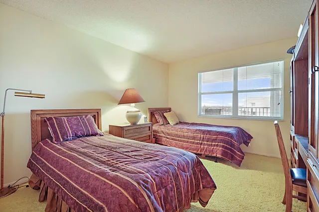 a bedroom with two beds and a window