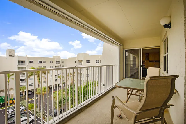 a view of swimming pool outdoor seating and city view