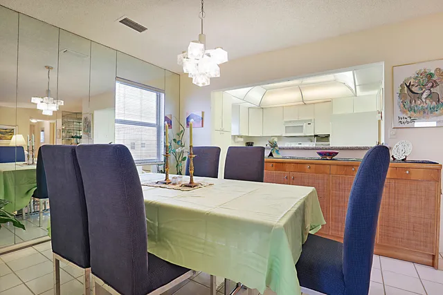 a view of a dining room with furniture and chandelier