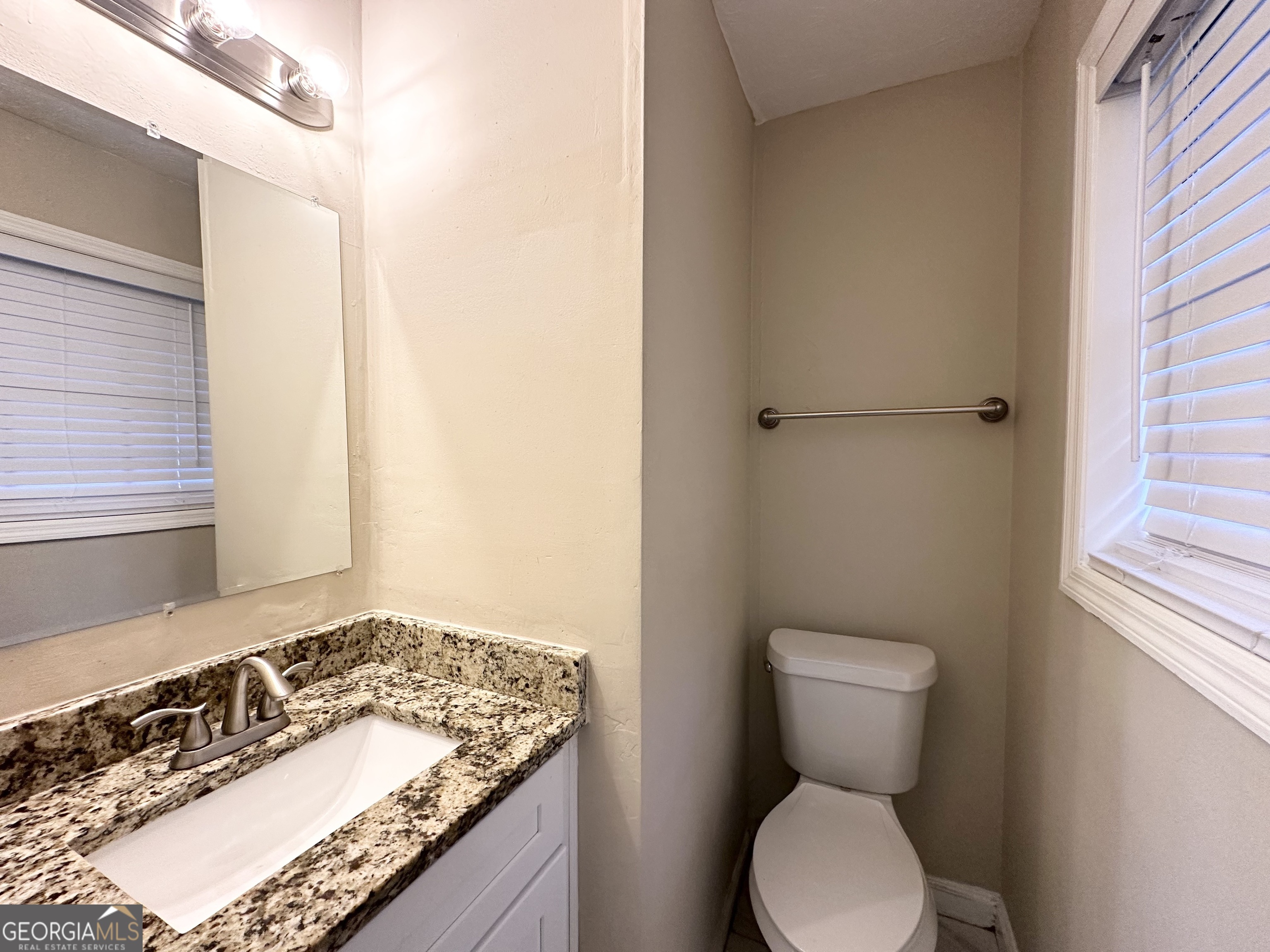 2749 Williamsburg Drive Decatur, GA 30034 - Photo 11 of 14 a bathroom with a granite countertop sink toilet and a mirror