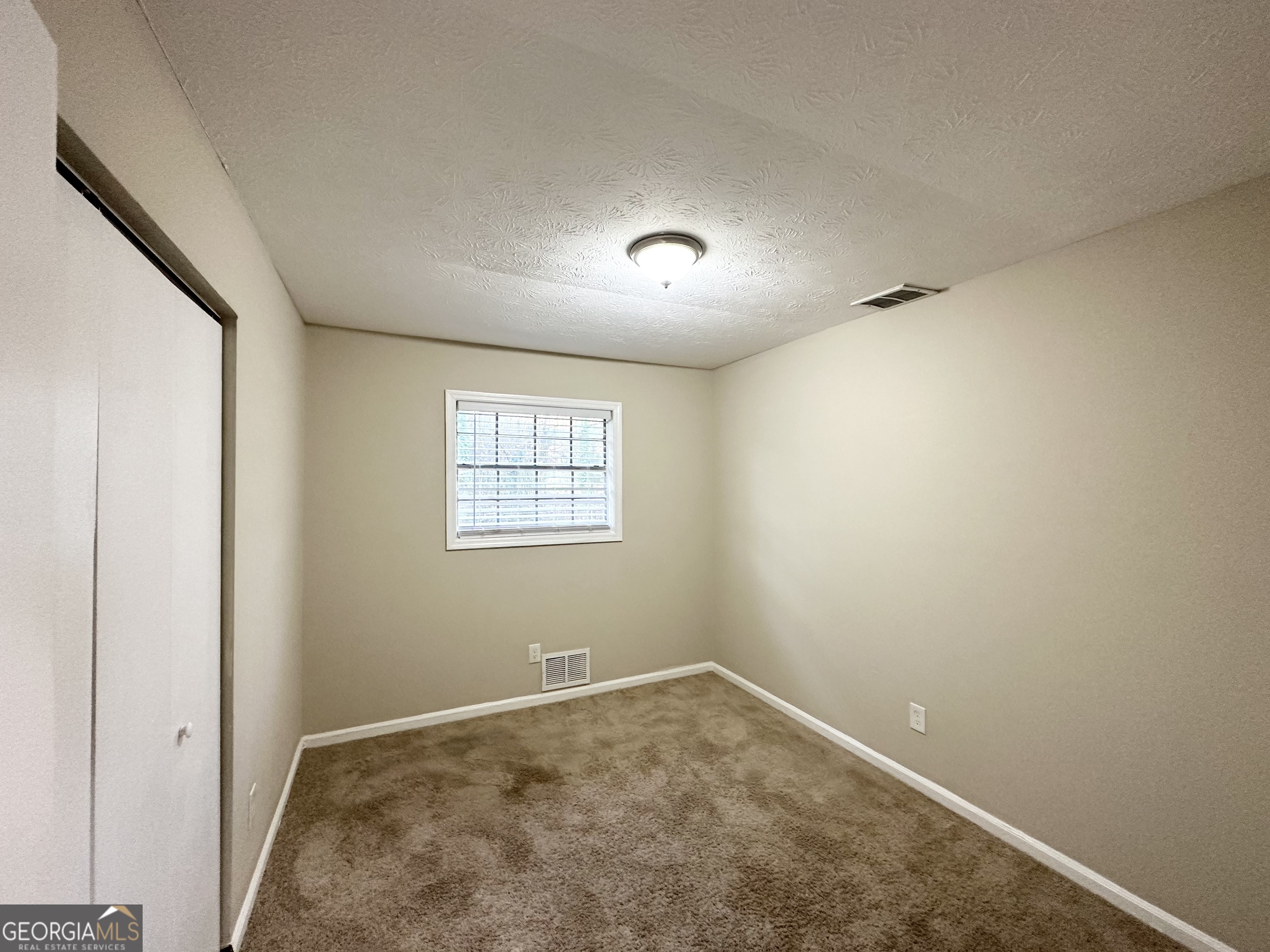 2749 Williamsburg Drive Decatur, GA 30034 - Photo 13 of 14 an empty room with a window