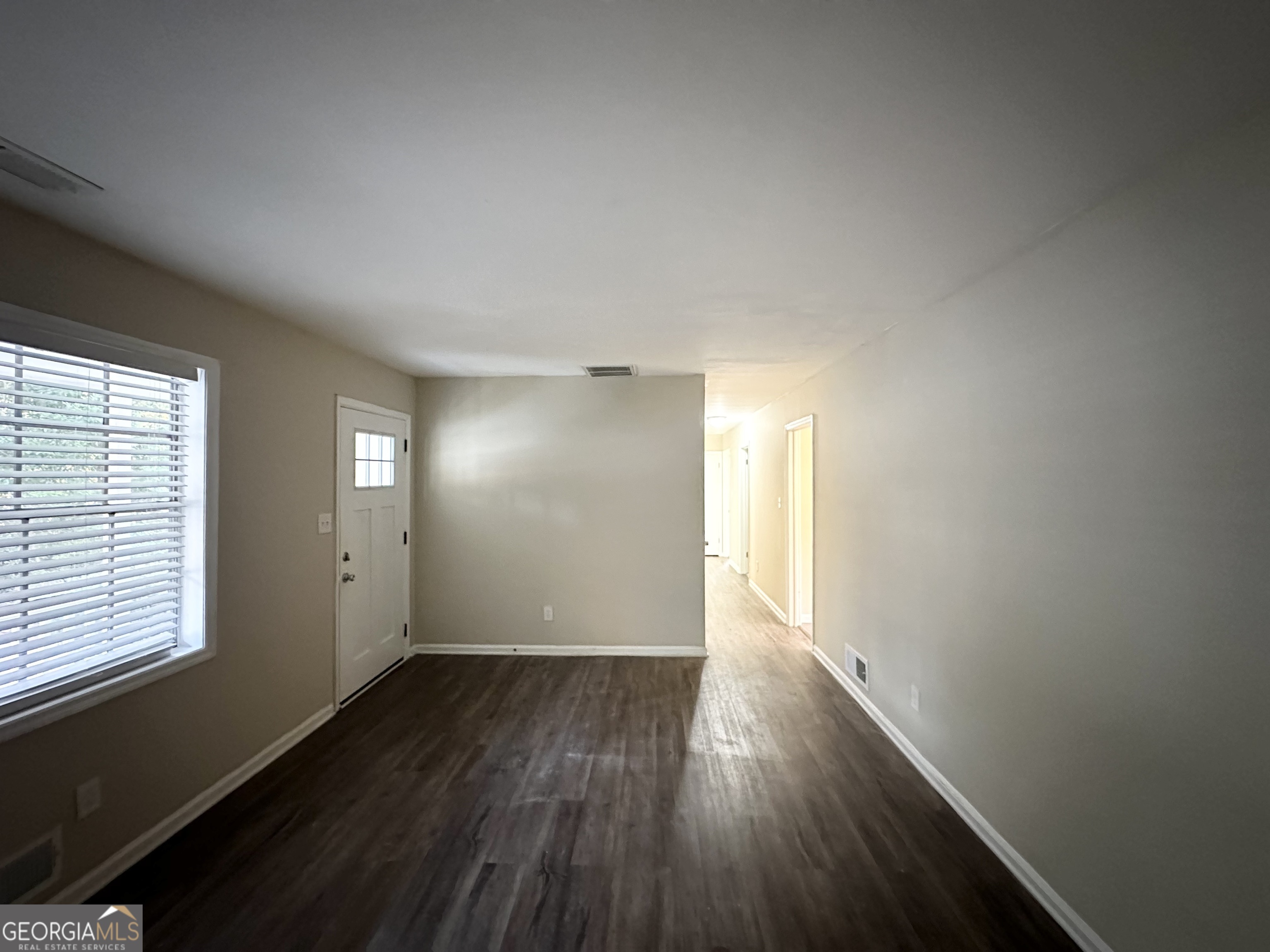 2749 Williamsburg Drive Decatur, GA 30034 - Photo 4 of 14 an empty room with wooden floor and windows