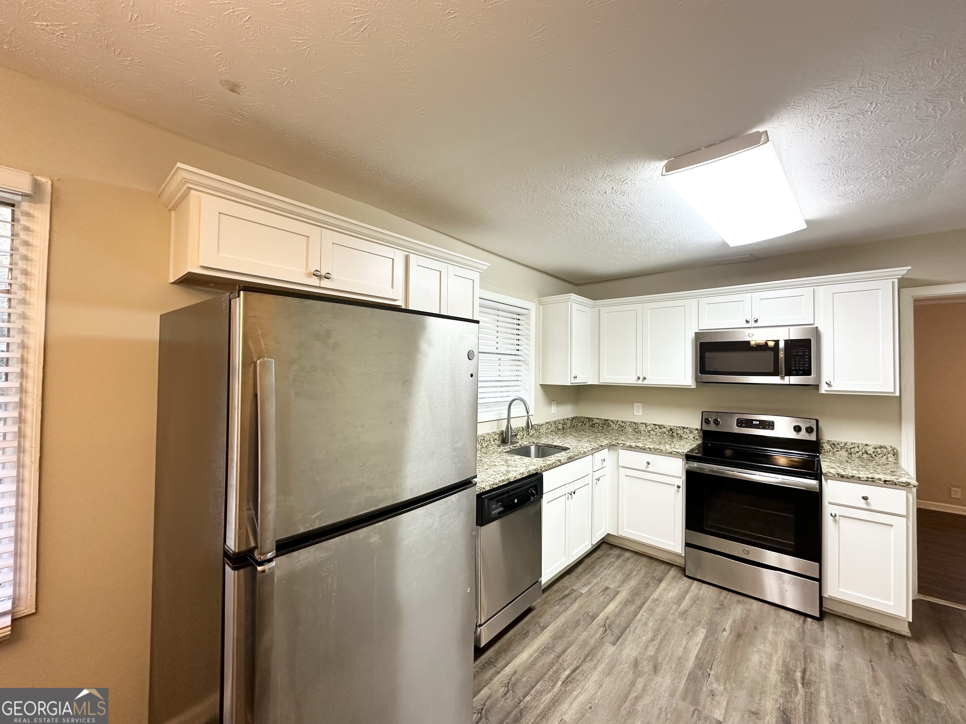 2749 Williamsburg Drive Decatur, GA 30034 - Photo 6 of 14 a kitchen with stainless steel appliances a refrigerator sink and microwave