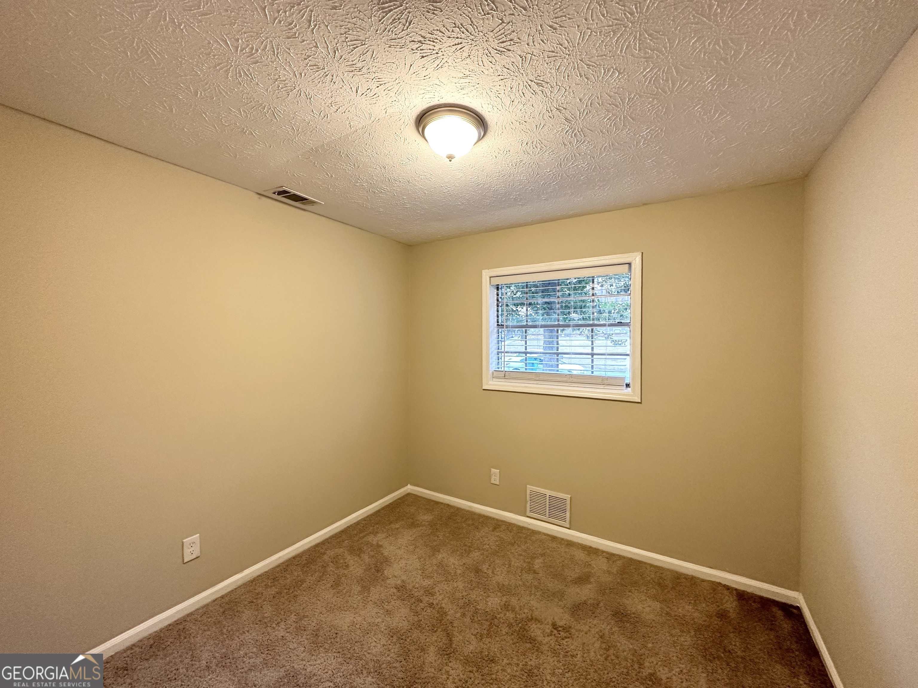 2749 Williamsburg Drive Decatur, GA 30034 - Photo 8 of 14 an empty room with a empty space and window