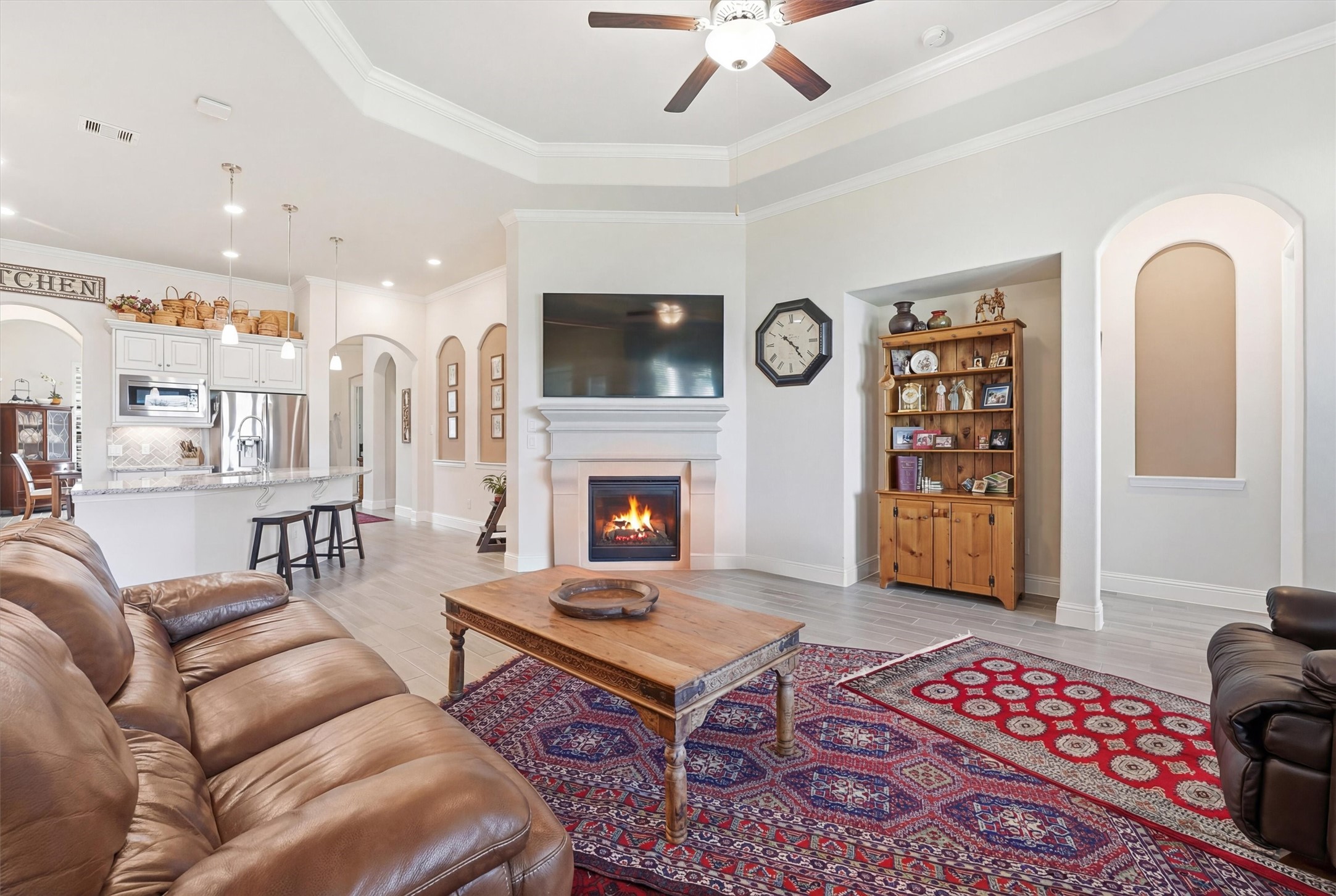 9307 Providence Bend Lane Houston, TX 77365 - Photo 8 of 45 Family room with a cozy fireplace, open to the kitchen and breakfast area