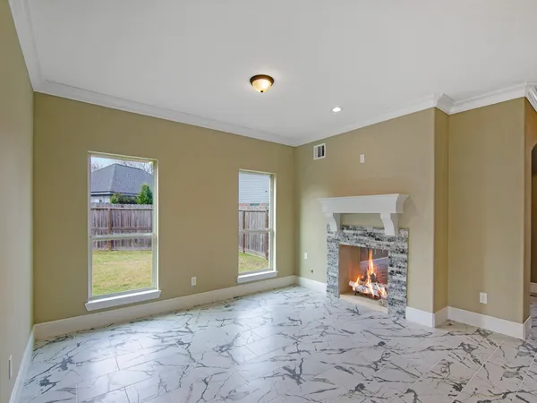 a view of a livingroom with a fireplace and a window