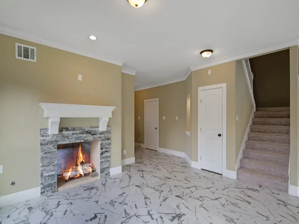 a view of an empty room and fire place