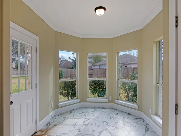 a view of an empty room with glass door and balcony