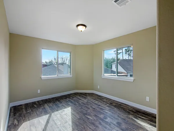 a view of room with window and wooden floor