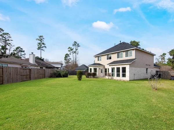 a big house with a big yard and large trees