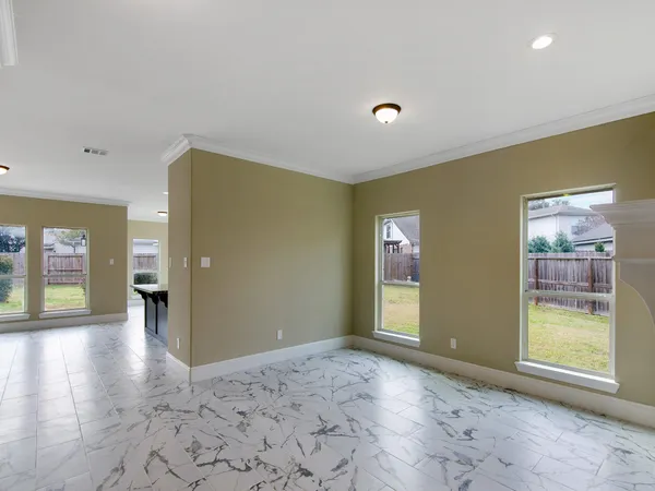 a view of a hallway with wooden floor and windows