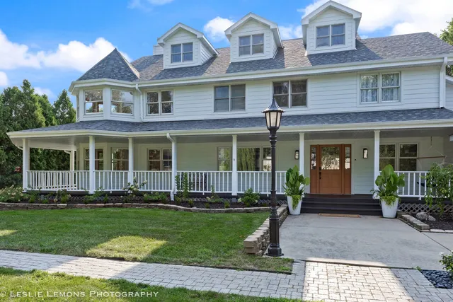 front view of a brick house with a yard