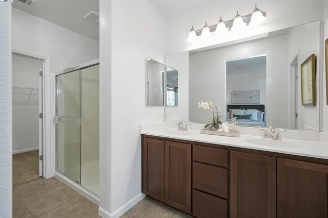 a bathroom with a sink double vanity and a mirror