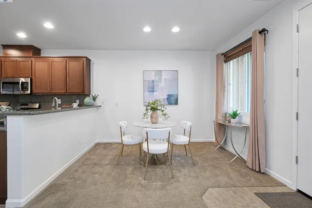 a dining room with furniture a window and a kitchen view