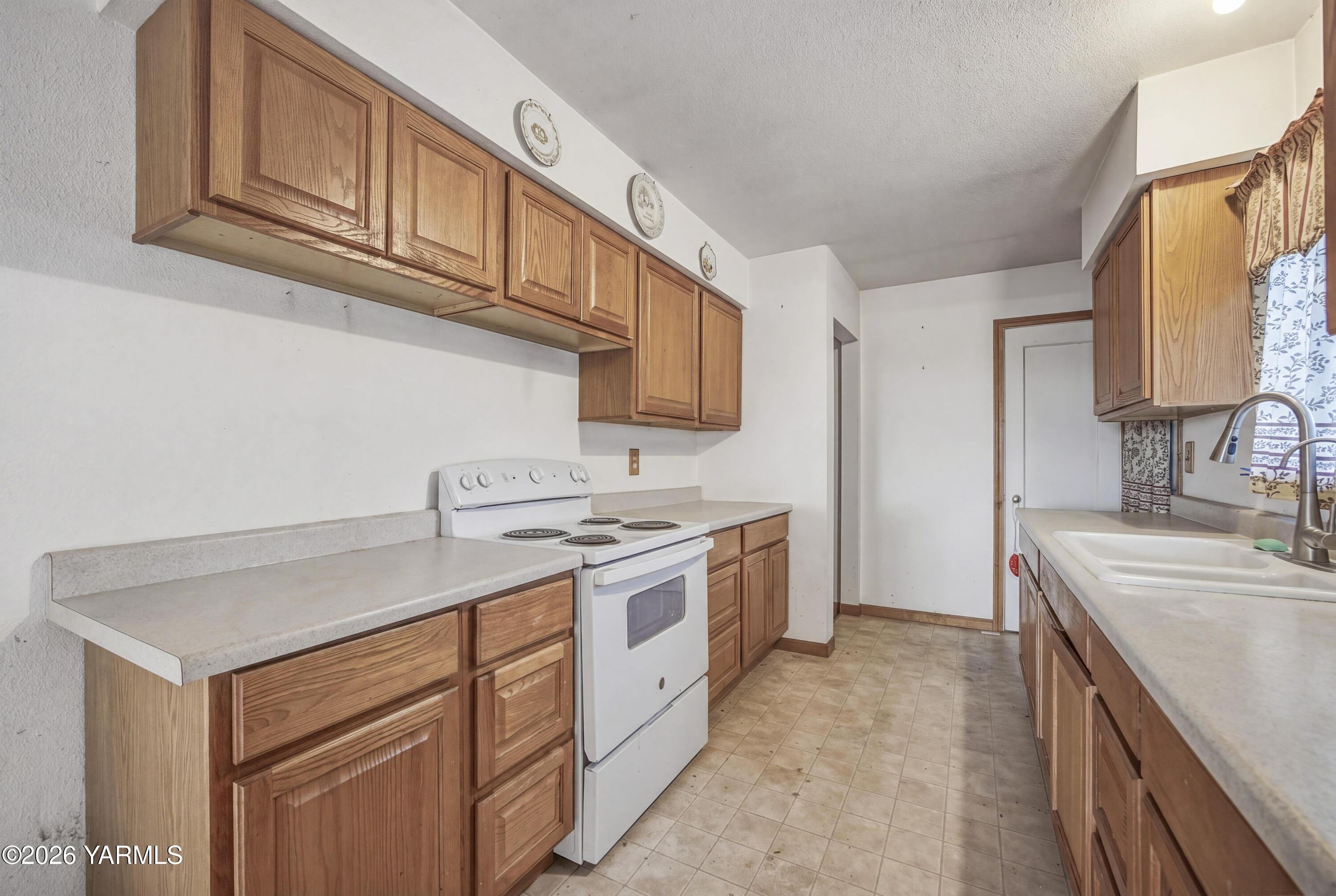 36322 D Mccall Road North Benton City, WA 99320 - Photo 30 of 39 a kitchen with a sink stove and cabinets