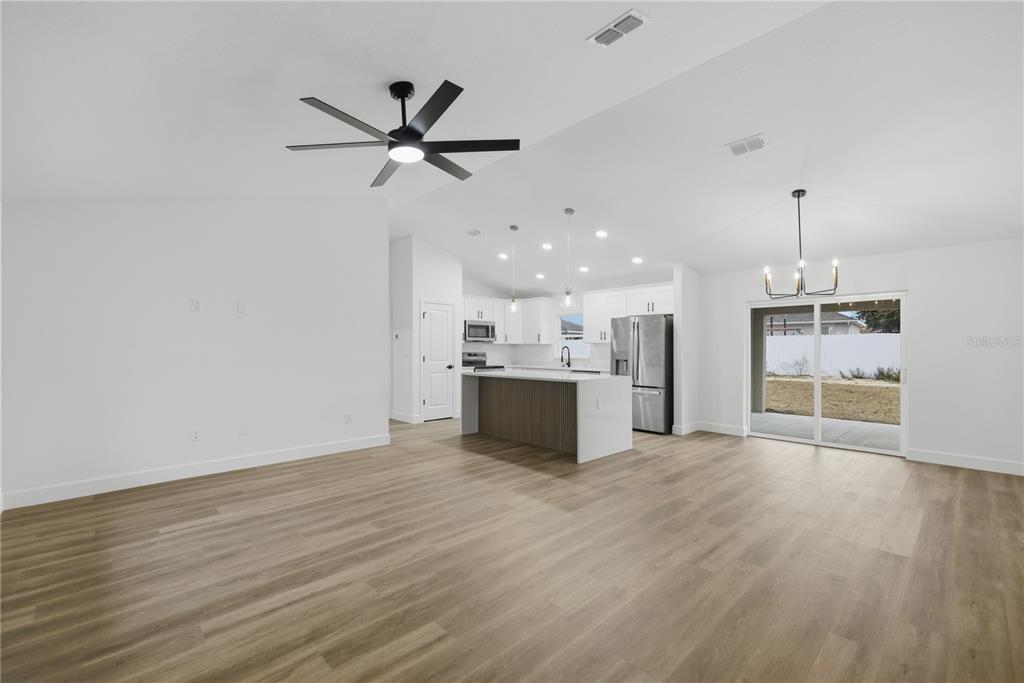 23 Juniper Loop Court Ocala, FL 34480 - Photo 2 of 25 a view of a kitchen with a sink wooden floor and a window