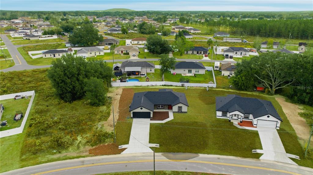 23 Juniper Loop Court Ocala, FL 34480 - Photo 25 of 25 an aerial view of residential houses with outdoor space and swimming pool