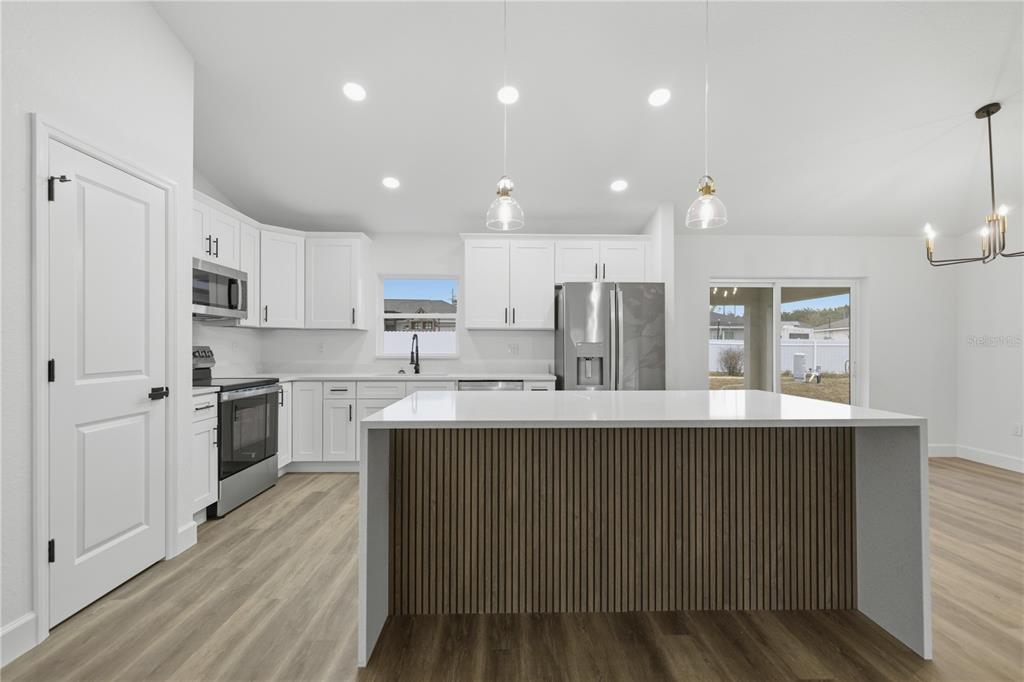 23 Juniper Loop Court Ocala, FL 34480 - Photo 5 of 25 a kitchen with counter top space cabinets and a sink