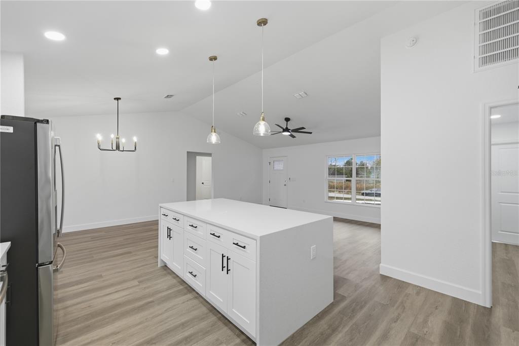23 Juniper Loop Court Ocala, FL 34480 - Photo 9 of 25 a kitchen that has a lot of cabinets and wooden floor
