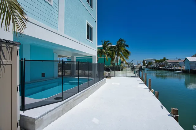 a large living room with stainless steel appliances granite countertop couches a coffee table and chairs in it