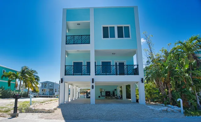 a kitchen with granite countertop a table chairs microwave and cabinets