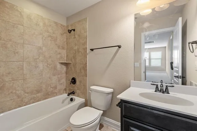 a bathroom with a sink a toilet a mirror and shower