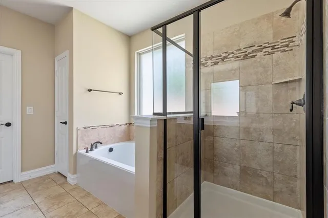 a bathroom with a bathtub and a shower