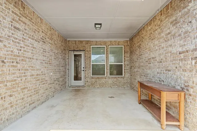a view of a house with wooden fence