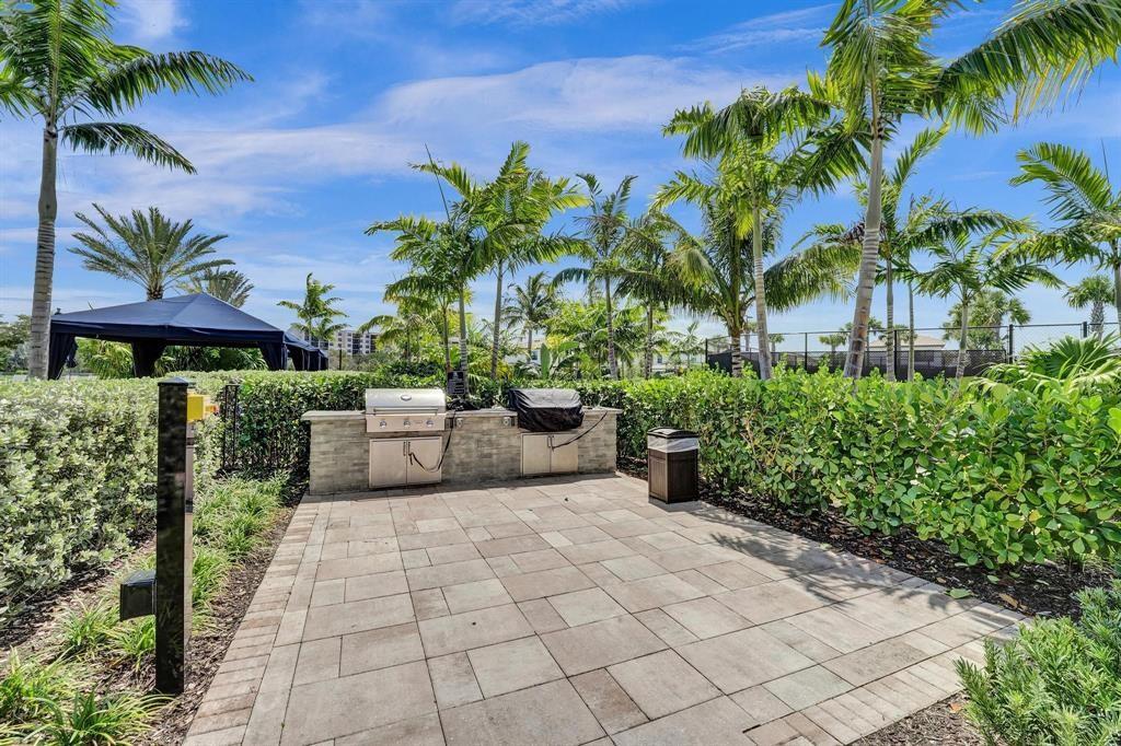 2178 Appleton Circle South Oakland Park, FL 33309 - Photo 21 of 22 a view of a patio with plants and palm trees