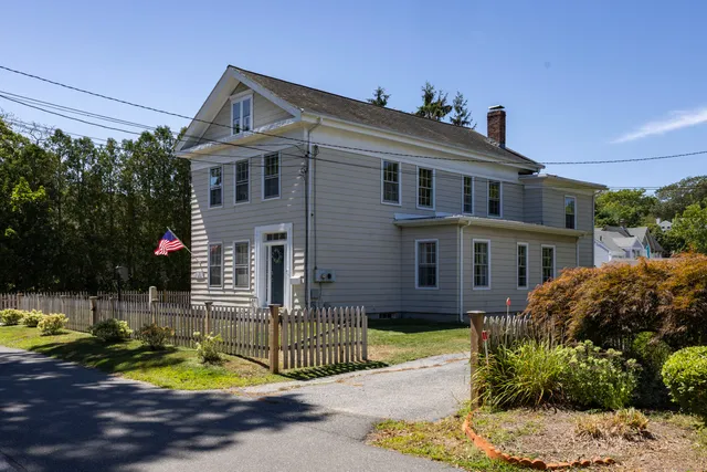 a view of a house with a small yard and plants