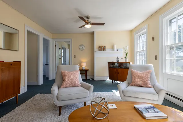 a living room with furniture rug and window