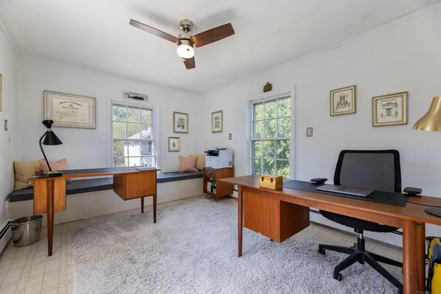 a living room with furniture piano and a window