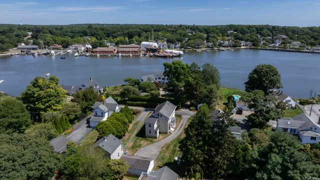 an aerial view of a house with a garden and lake view