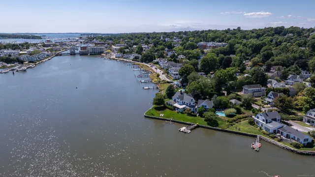 an aerial view of a residential houses with outdoor space and street view