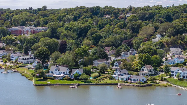 an aerial view of a houses with a lake view