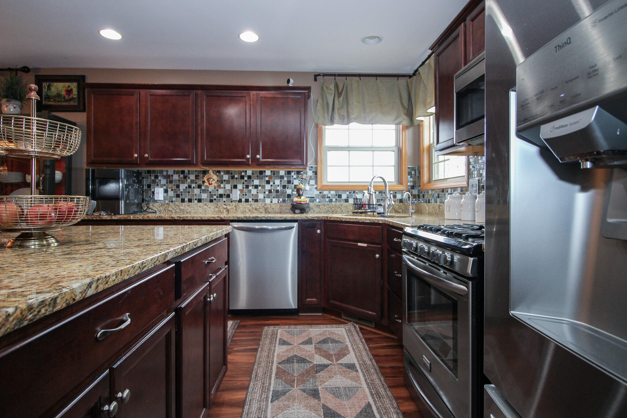 2913 Cardinal Drive Wheatfield, IN 46392 - Photo 13 of 34 a kitchen with stainless steel appliances granite countertop a sink stove and cabinets